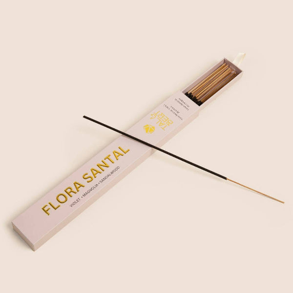 Incense sticks with 'Flora Santal' packaging on a beige background