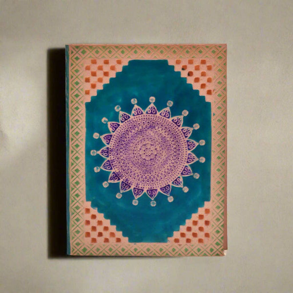 Decorative notebook with a mandala design on a plain background