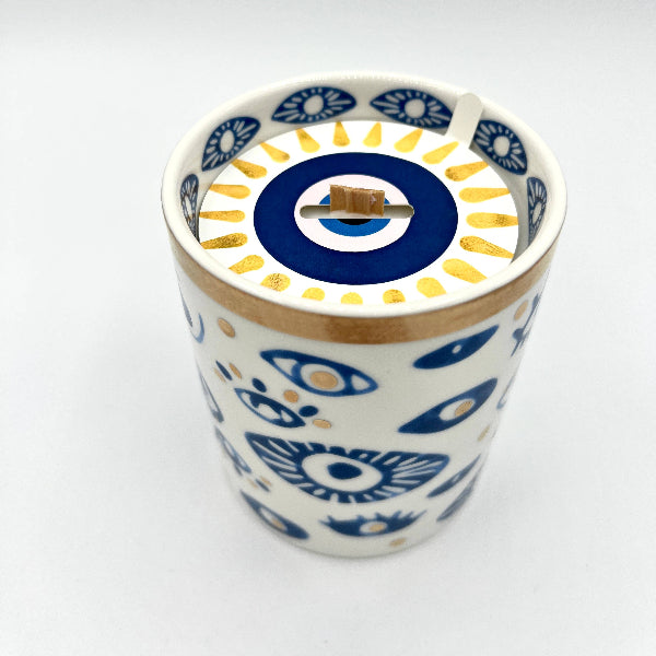 Ceramic tumbler with blue and white floral pattern on a white background