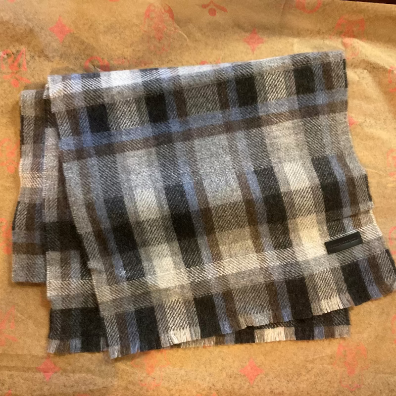 Plaid fabric with navy blue, black, white, and gray pattern on a textured surface