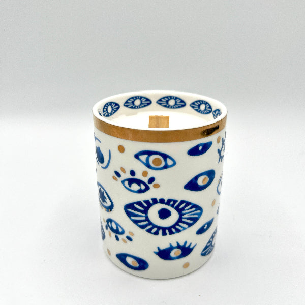 Ceramic mug with blue eye pattern on a white background