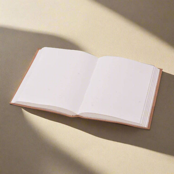 Open book with blank pages on a textured surface